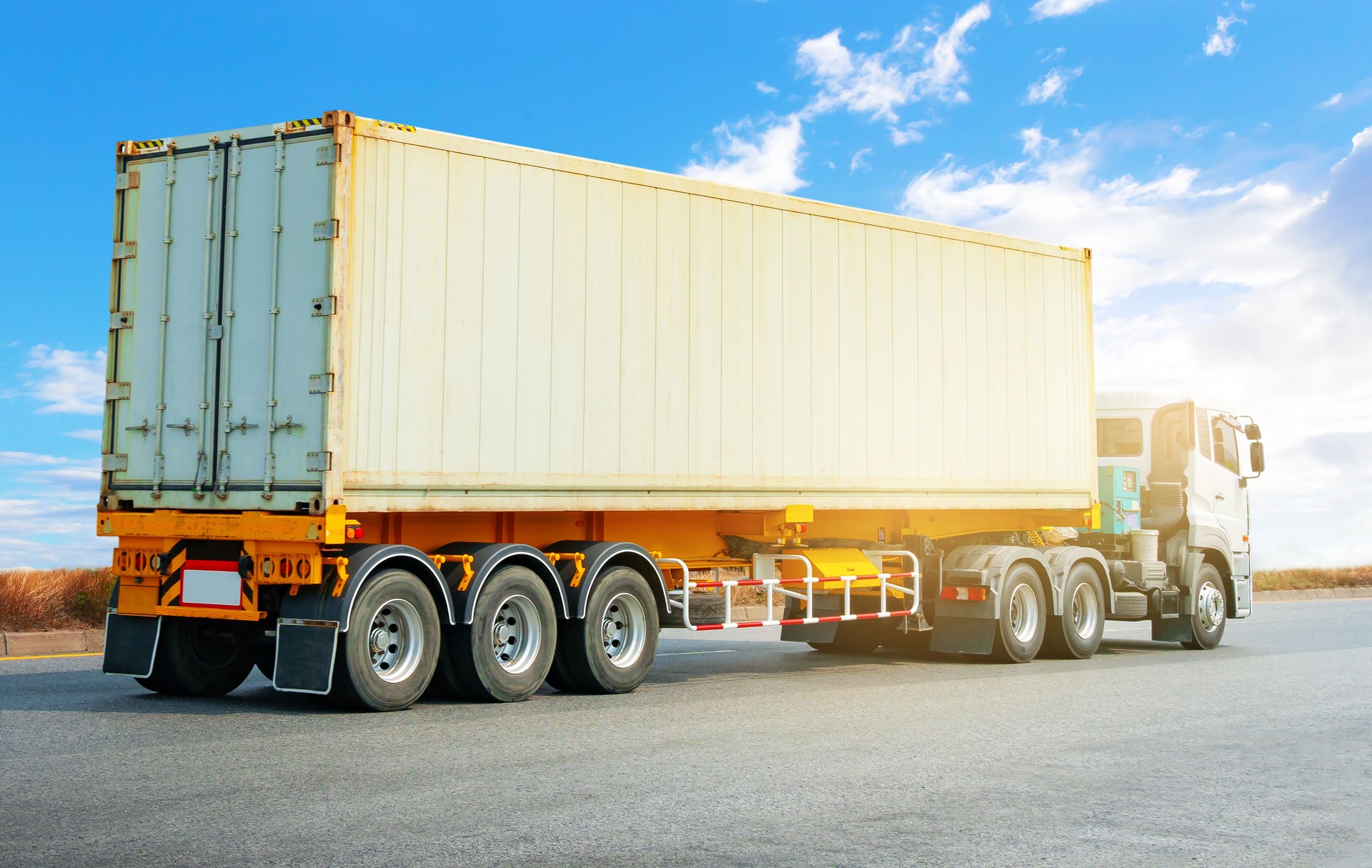 Semi Trailer Trucks Driving on The Road. Freezer Containers, Temperature-Controlled cargo Containers. Economical Transportation Logistics Industry.  Freight Truck Logistics Transportation.
